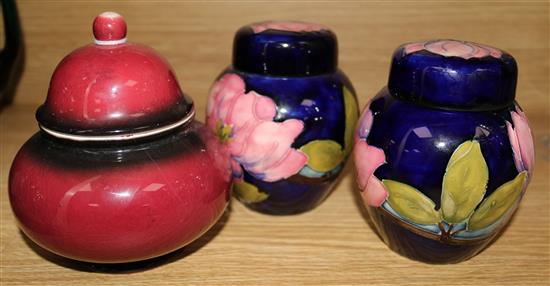 A pair of Moorcroft Clematis pattern jars and covers, a Carltonware Rouge Royale vase and cover